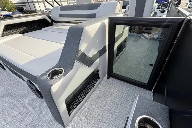 Slide: The Image of 2026 Alera M25L boat interior with cushioned seating and cup holders. - 4