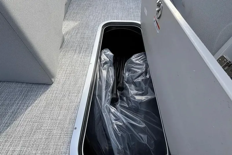 Slide: The Image of Open storage compartment in 2026 Alera M25L boat with plastic-wrapped contents. - 5