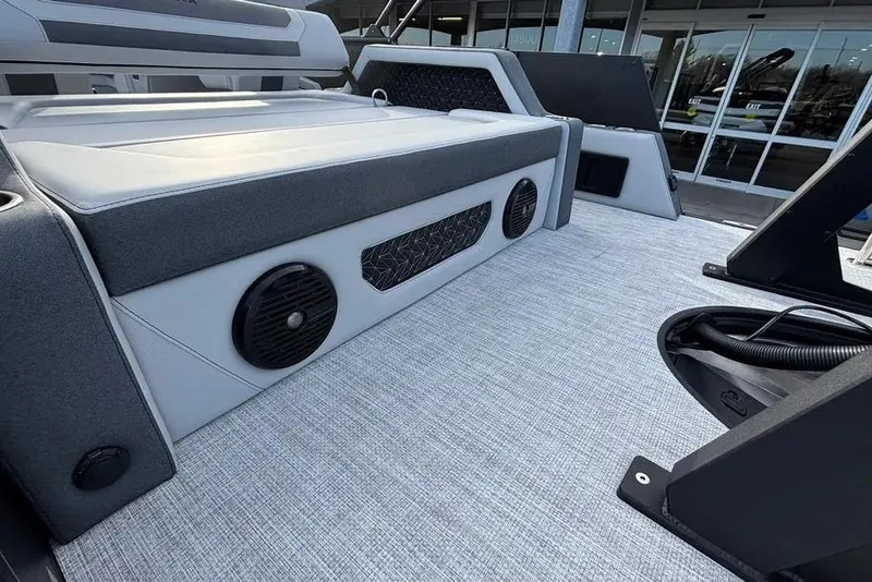 Slide: The Image of 2026 Alera M25L boat interior with cushioned seating and built-in speakers. - 6