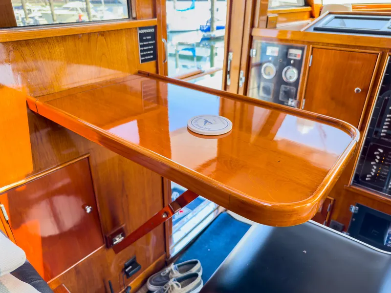 Slide: The Image of Interior of 1971 Burger 64 Pilothouse Motoryacht with wooden table. - 16