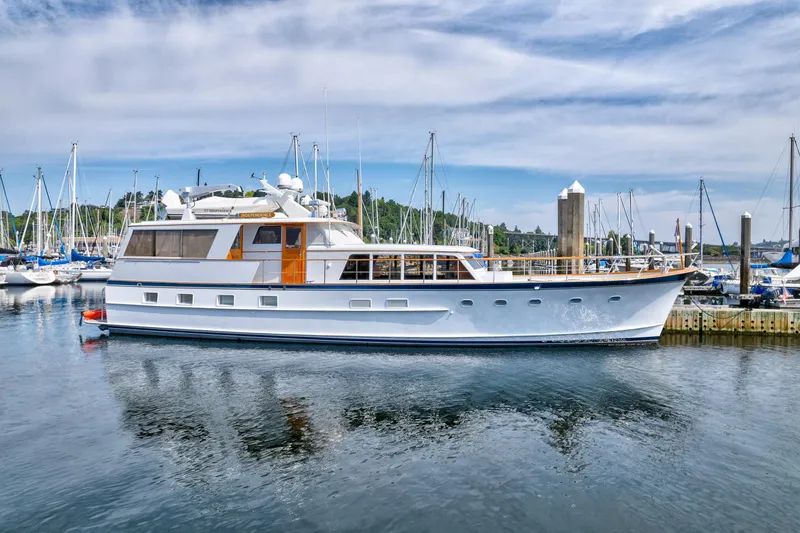 Slide: The Image of 1971 Burger 64 Pilothouse Motoryacht docked, surrounded by sailboats. - 2