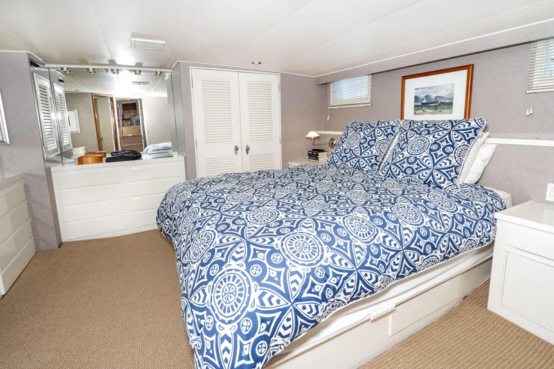 Slide: The Image of Interior of Burger 64 Pilothouse Motoryacht, bedroom with blue patterned bedding. - 36