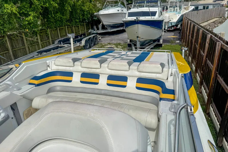 Slide: The Image of 2006 Formula 382 FASTech boat interior with colorful seating, parked near other boats. - 10