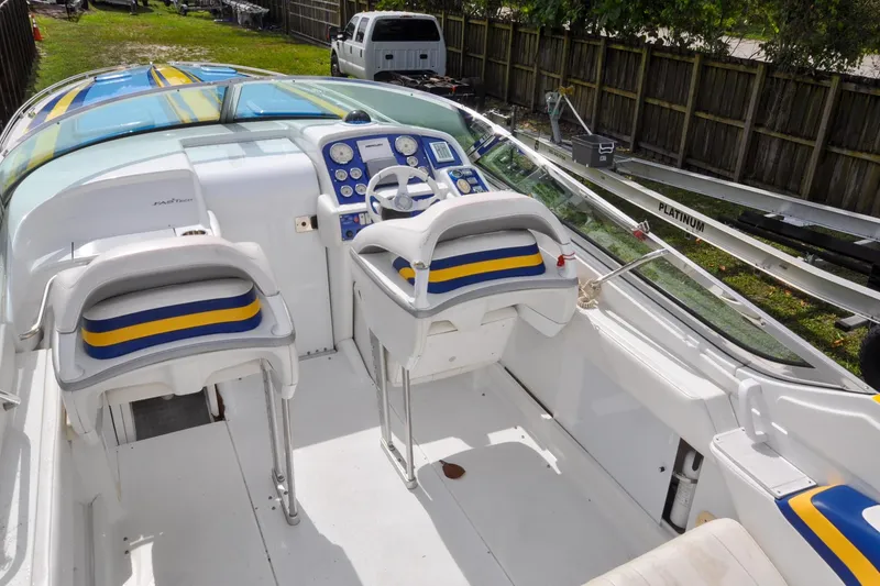 Slide: The Image of 2006 Formula 382 FASTech boat interior with blue and yellow accents, featuring dual seating and control panel. - 11