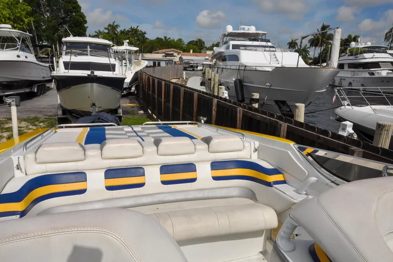 Slide: The Image of 2006 Formula 382 FASTech boat docked among other yachts in a marina setting. - 12