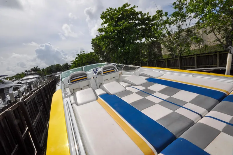 Slide: The Image of 2006 Formula 382 FASTech boat with colorful seating, docked near trees and other boats. - 13
