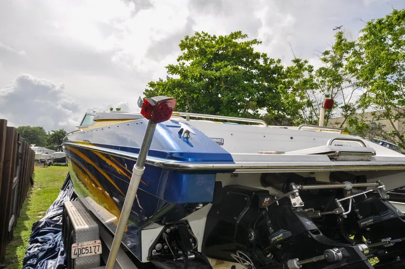 Slide: The Image of 2006 Formula 382 FASTech boat on trailer, parked outdoors with trees in background. - 16
