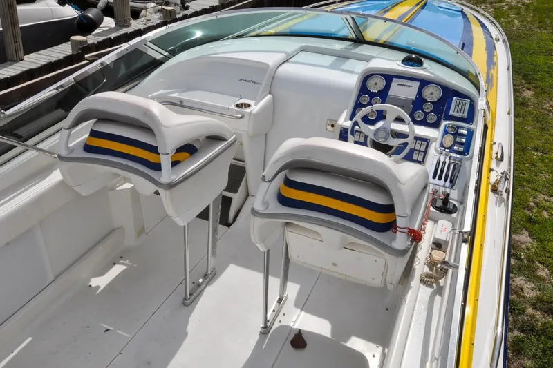Slide: The Image of 2006 Formula 382 FASTech boat cockpit with dual seats and detailed control panel. - 2
