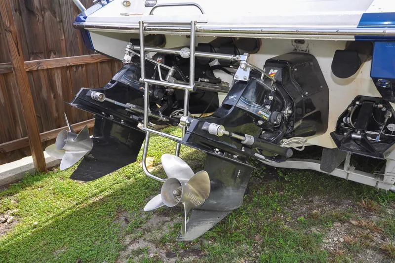 Slide: The Image of 2006 Formula 382 FASTech boat with dual propellers and outboard motors, parked on grass. - 20