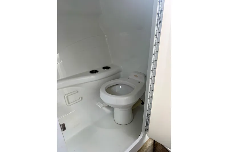 Slide: The Image of 2006 Formula 382 FASTech boat bathroom interior with white toilet and compact design. - 24