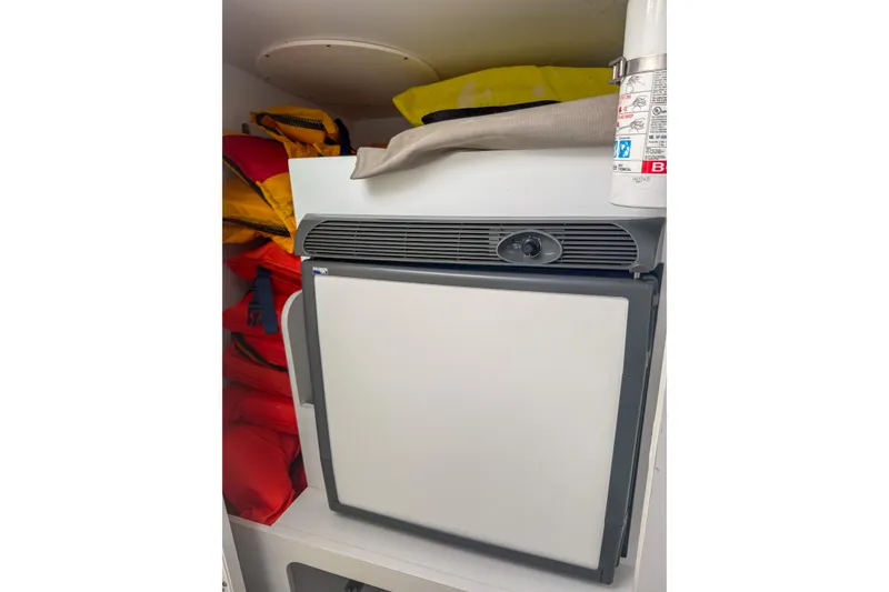 Slide: The Image of Compact refrigerator in a 2006 Formula 382 FASTech boat cabin with life jackets and fire extinguisher. - 25
