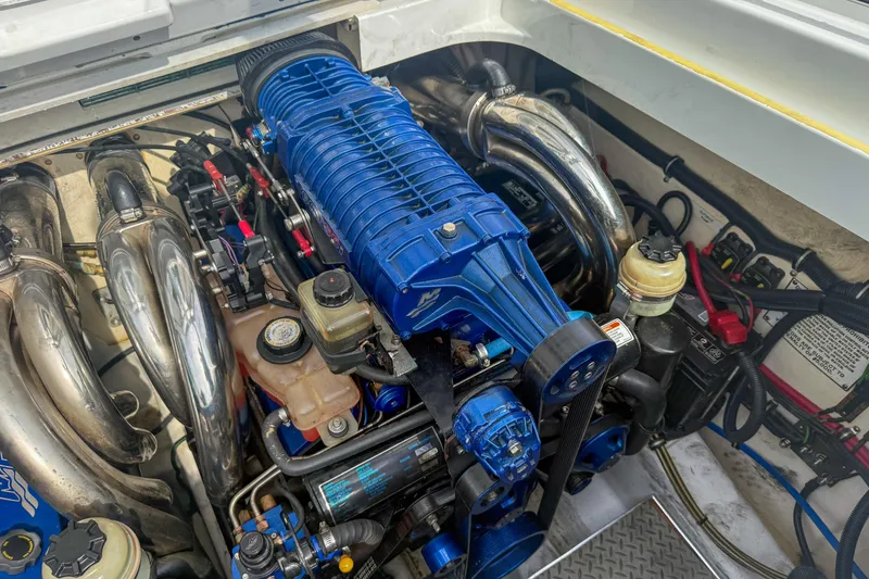 Slide: The Image of Engine compartment of a 2006 Formula 382 FASTech boat, featuring a blue supercharger. - 28