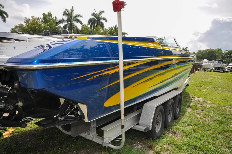 Slide: The Image of 2006 Formula 382 FASTech boat with vibrant blue and yellow design on a trailer. - 33