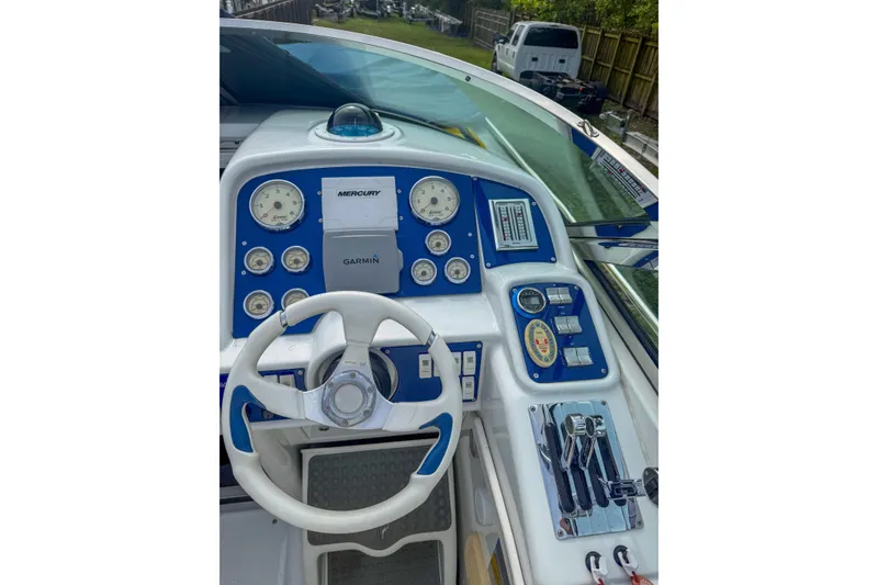 Slide: The Image of 2006 Formula 382 FASTech boat dashboard with steering wheel and navigation instruments. - 4