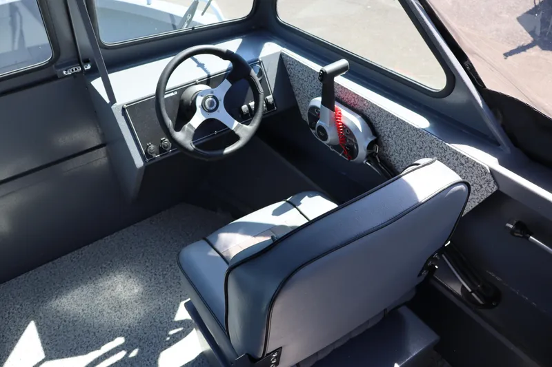 Slide: The Image of Interior of 2026 Alumaweld Talon 18 boat, featuring steering wheel and control panel. - 15