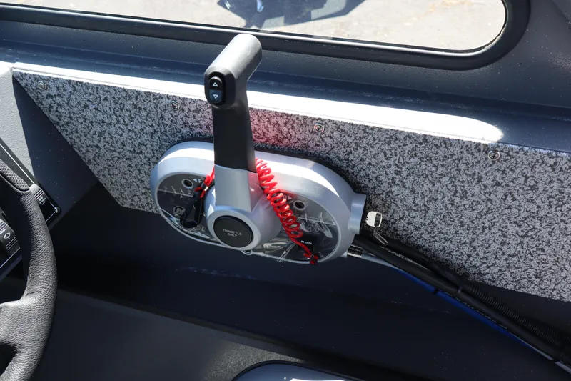 Slide: The Image of Throttle control panel of 2026 Alumaweld Talon 18 boat with red safety cord. - 17