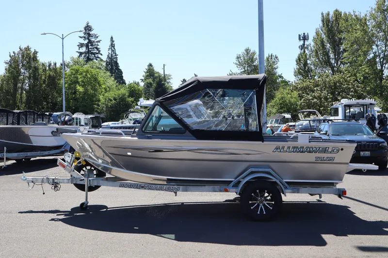 Slide: The Image of 2026 Alumaweld Talon 18 boat on trailer in outdoor dealership lot. - 2
