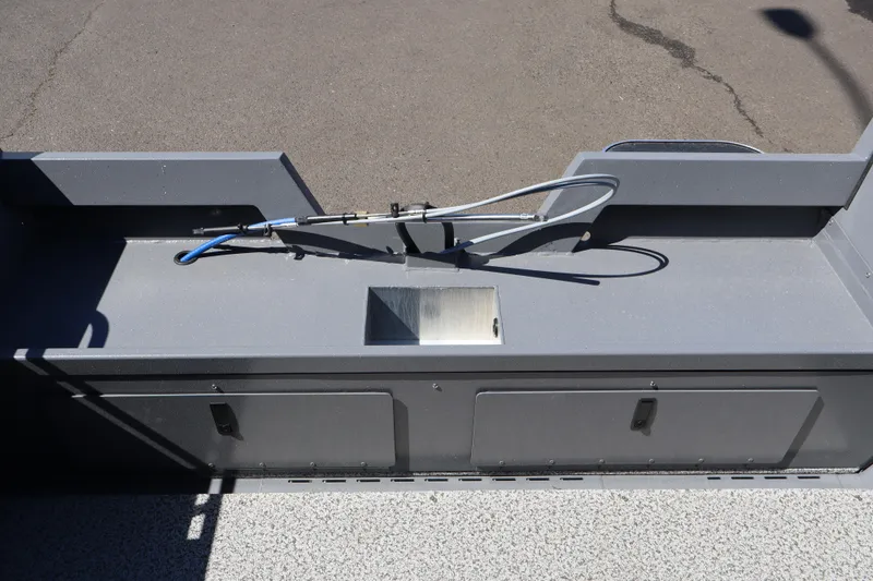 Slide: The Image of 2026 Alumaweld Talon 18 boat interior with storage compartments and hose setup. - 8