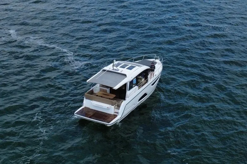 Slide: The Image of 2022 Sealine C430 yacht cruising on open water, aerial view. - 10