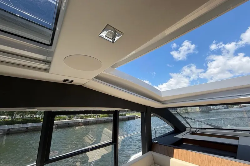 Slide: The Image of Interior view of 2022 Sealine C430 yacht with panoramic sunroof and waterway backdrop. - 100