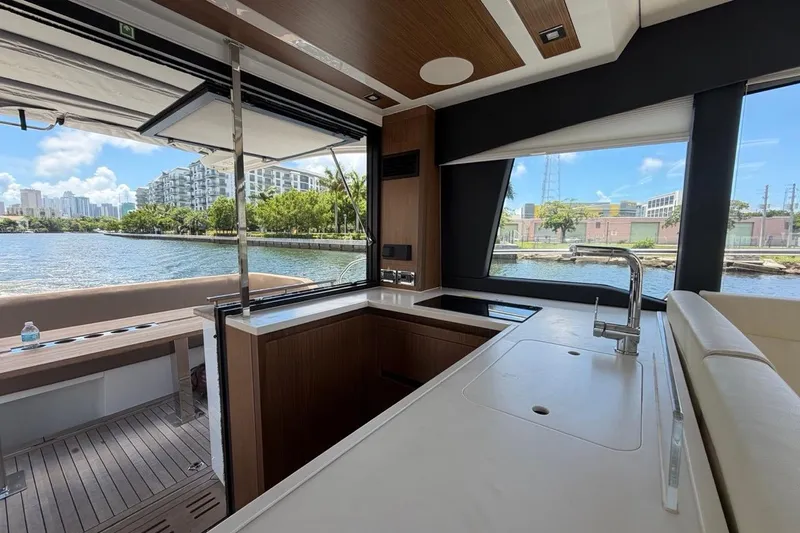 Slide: The Image of Interior view of 2022 Sealine C430 yacht kitchen with waterfront backdrop. - 104