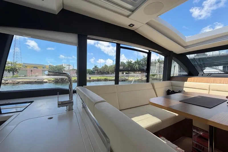 Slide: The Image of Interior of 2022 Sealine C430 yacht with spacious seating and scenic waterway view. - 105