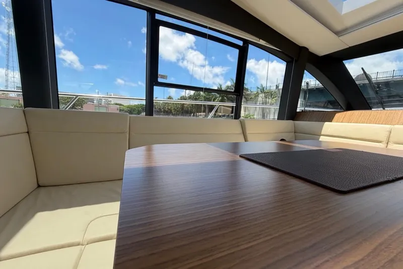 Slide: The Image of Interior of 2022 Sealine C430 yacht with beige seating and wooden table. - 106