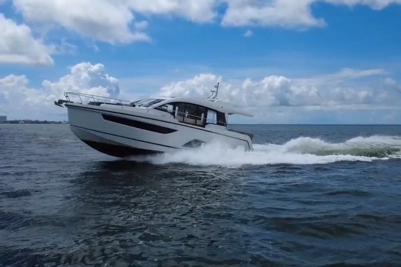 Slide: The Image of 2022 Sealine C430 yacht cruising on open water under a clear blue sky. - 13