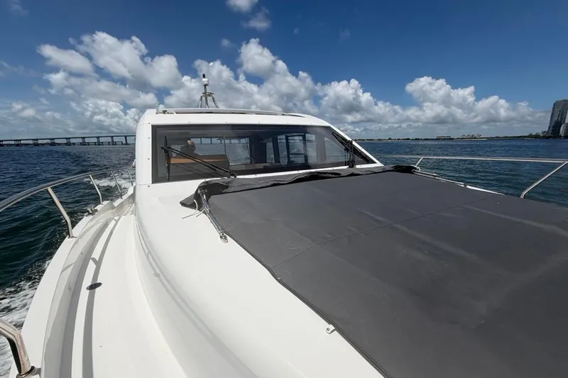 Slide: The Image of 2022 Sealine C430 yacht cruising on open water under a clear blue sky. - 17