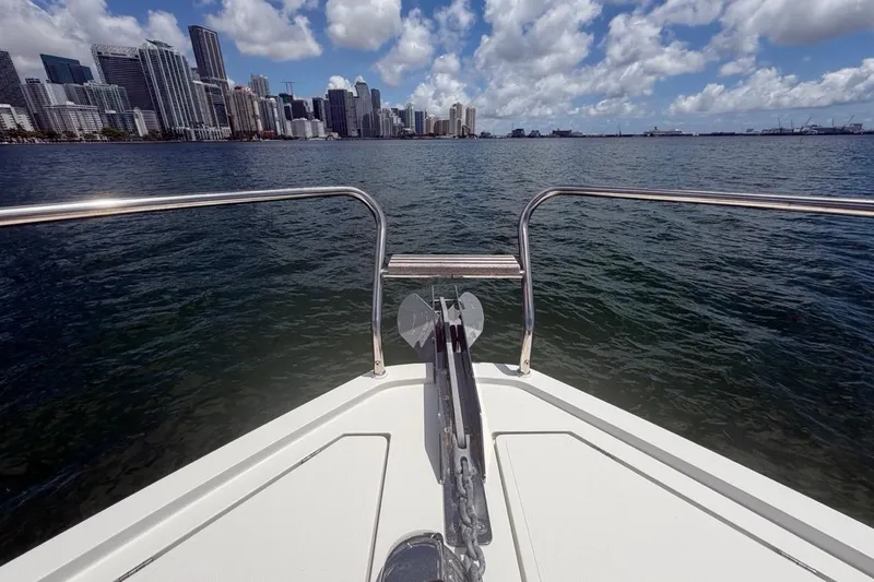 Slide: The Image of Bow view from 2022 Sealine C430 yacht, overlooking city skyline and ocean under cloudy sky. - 18