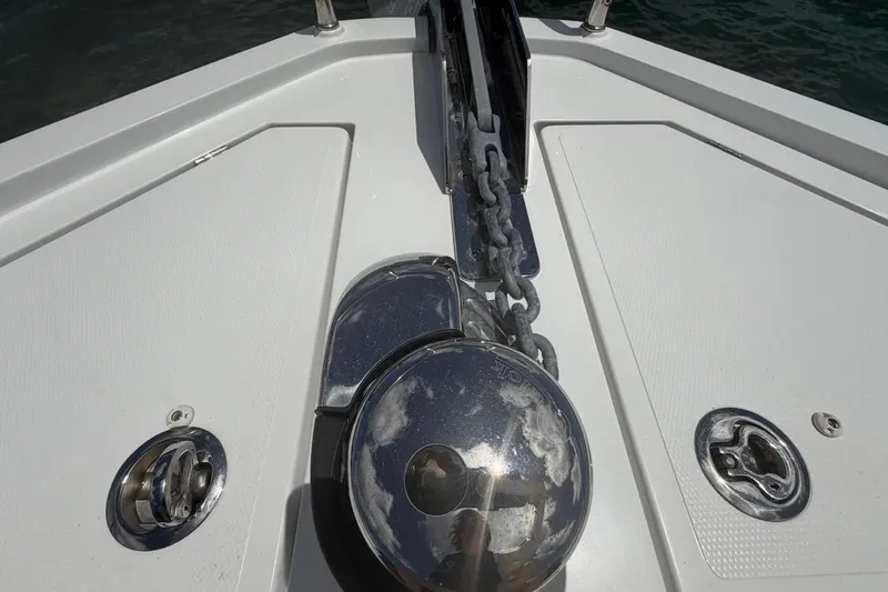 Slide: The Image of Anchor chain mechanism on 2022 Sealine C430 yacht deck, featuring polished metal components. - 21