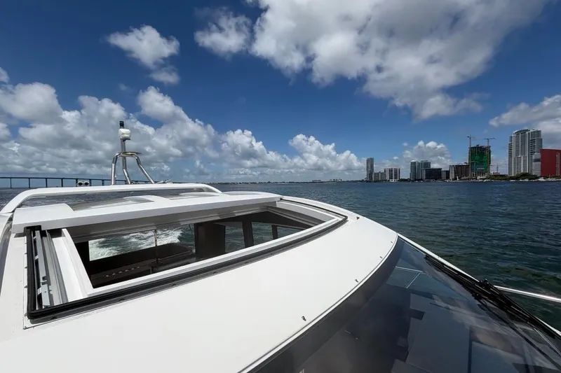 Slide: The Image of 2022 Sealine C430 yacht cruising near city skyline under blue sky. - 22