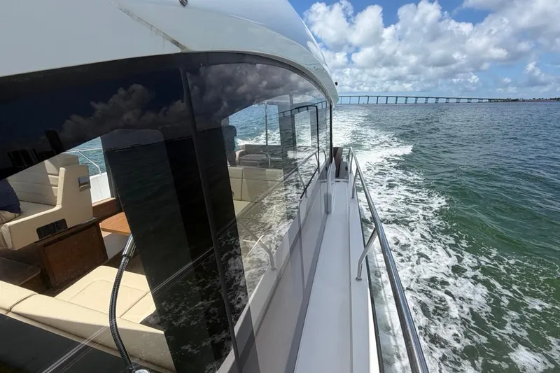 Slide: The Image of 2022 Sealine C430 yacht cruising on open water under a blue sky. - 23