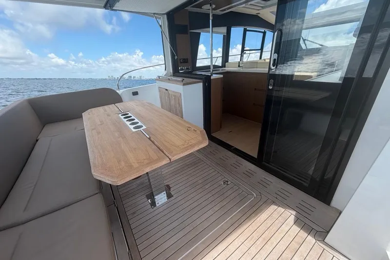 Slide: The Image of Luxury 2022 Sealine C430 yacht interior with wooden deck and seating area. - 34