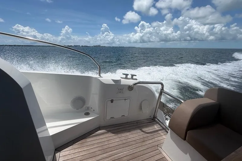 Slide: The Image of 2022 Sealine C430 yacht cruising on open water under a clear blue sky. - 37