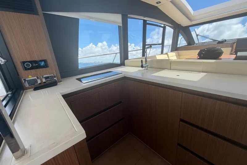 Slide: The Image of Modern kitchen interior of 2022 Sealine C430 yacht with sleek wood cabinetry and ocean view. - 40