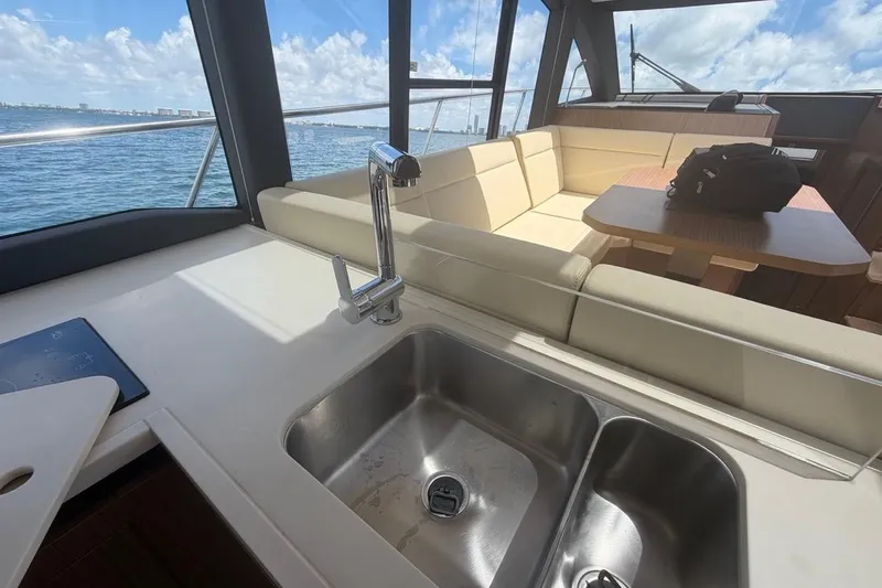 Slide: The Image of Interior of 2022 Sealine C430 yacht with sink, seating, and ocean view. - 45