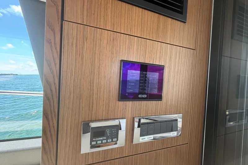 Slide: The Image of Control panel on 2022 Sealine C430 yacht with ocean view through window. - 47