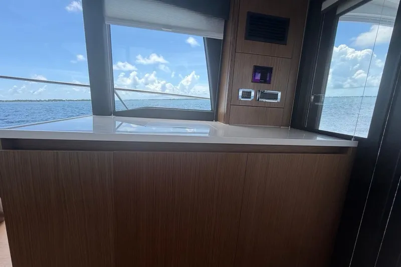 Slide: The Image of Interior view of 2022 Sealine C430 yacht with ocean backdrop and modern wood paneling. - 49