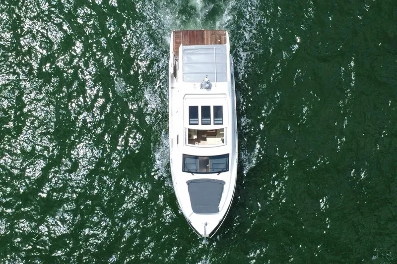 Slide: The Image of Aerial view of 2022 Sealine C430 yacht cruising on green water. - 5