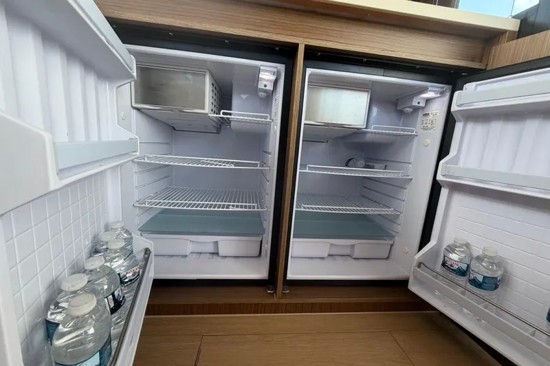 Slide: The Image of Dual refrigerators on 2022 Sealine C430 yacht, stocked with bottled water. - 50