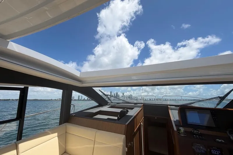 Slide: The Image of Interior view of 2022 Sealine C430 yacht with open sunroof and ocean backdrop. - 54