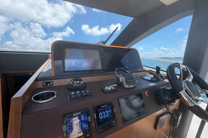 Slide: The Image of Helm of 2022 Sealine C430 yacht with navigation instruments and steering wheel. - 57
