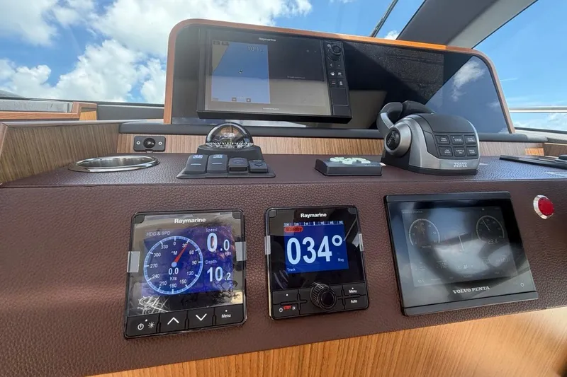 Slide: The Image of Sealine C430 2022 yacht dashboard with navigation and control systems under a clear sky. - 58