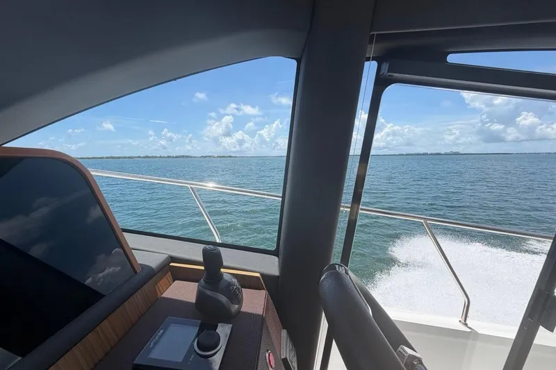 Slide: The Image of Interior view from a 2022 Sealine C430 yacht, overlooking the ocean on a sunny day. - 60