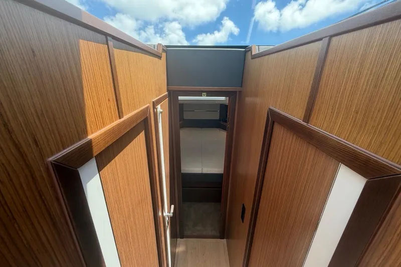 Slide: The Image of Interior view of 2022 Sealine C430 yacht, featuring wooden paneling and a skylight. - 61