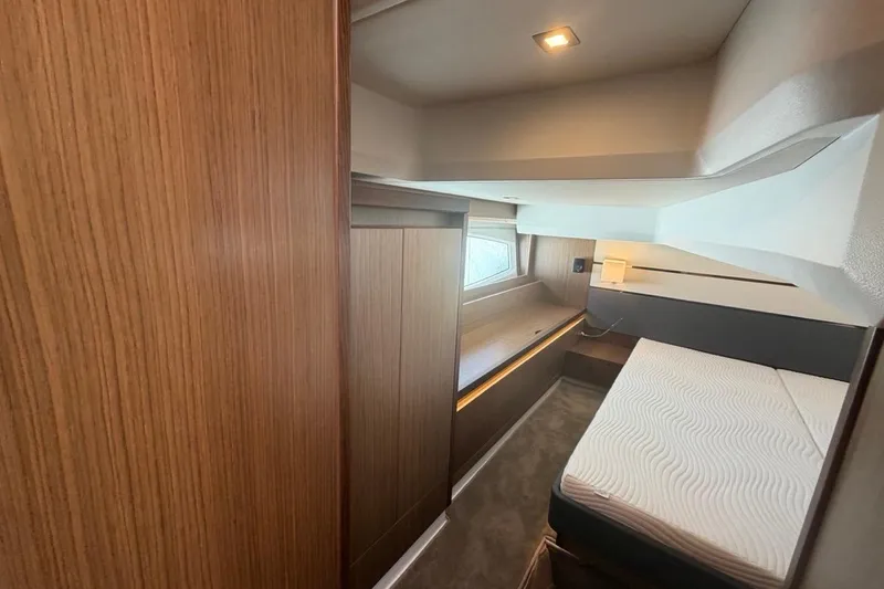 Slide: The Image of 2022 Sealine C430 yacht interior cabin with wooden paneling and modern design. - 66