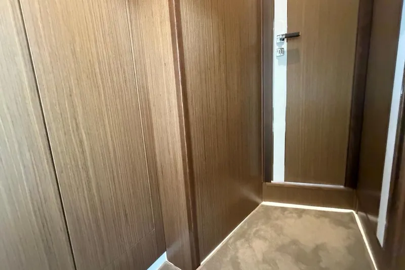 Slide: The Image of Interior of 2022 Sealine C430 yacht featuring sleek wooden paneling and modern design. - 70