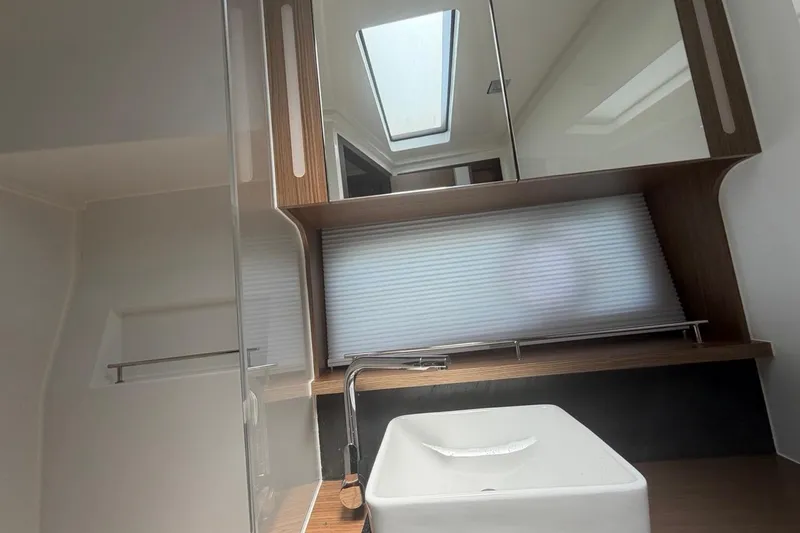 Slide: The Image of Modern bathroom interior of 2022 Sealine C430 yacht with skylight and sleek fixtures. - 74