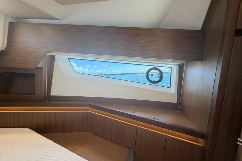 Slide: The Image of Interior cabin view of 2022 Sealine C430 yacht with wooden finish and ocean window. - 81